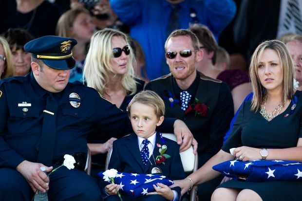 Family mourns at a police funeral.