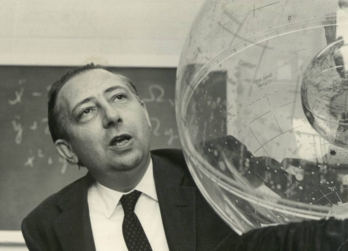 Black and white photo of a man with a celestial globe.