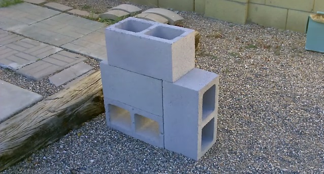 Stacked concrete blocks on gravel.