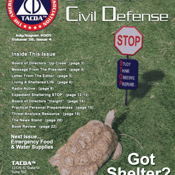 A turtle is walking on the grass with a stop sign.