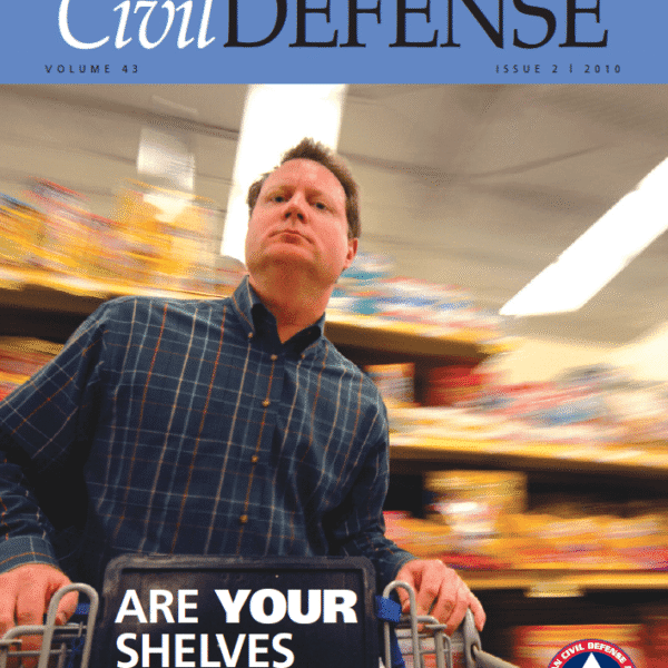 A man in a grocery store with a cart.