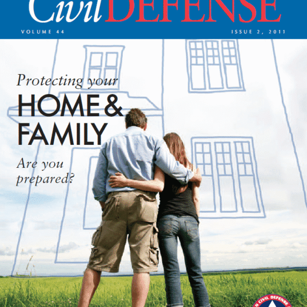 A couple is hugging in front of a drawing of their home.