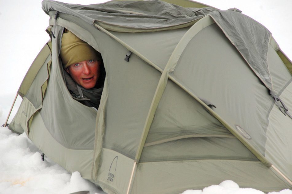 Person peeking out of snow tent.