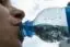 A person drinking water from a bottle