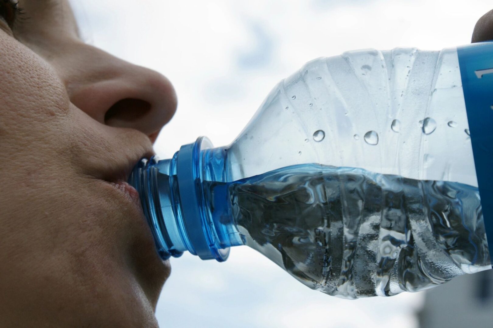 A person drinking water from a bottle