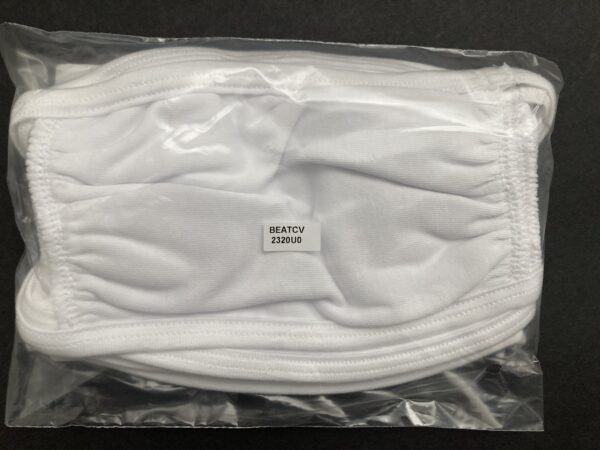 A white mask is in its plastic bag.