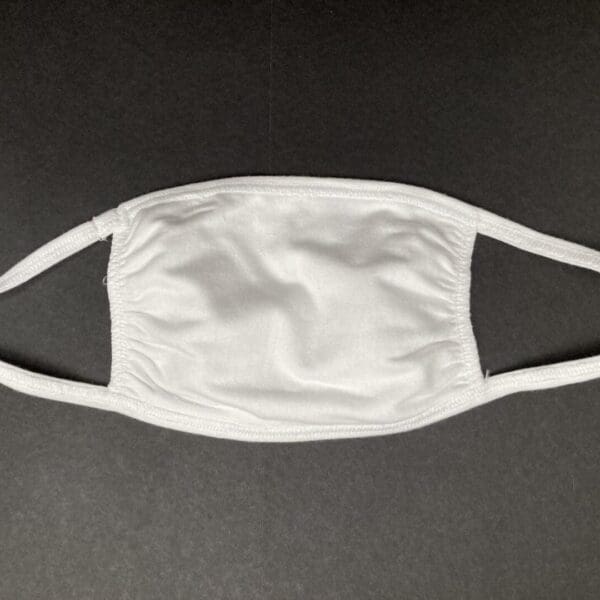 A white face mask is shown on the ground.