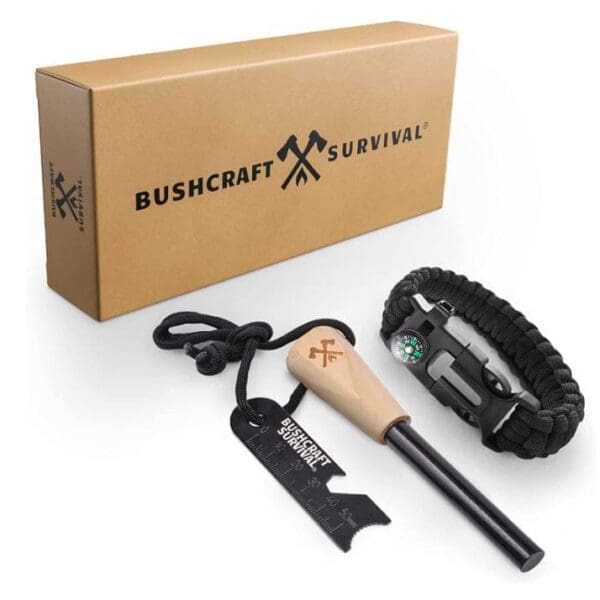 A box with a stick, compass and paracord bracelet.