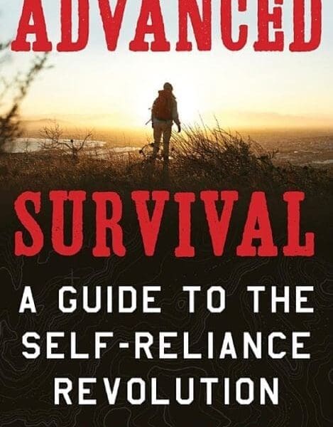 A person walking through the grass with an orange backpack.